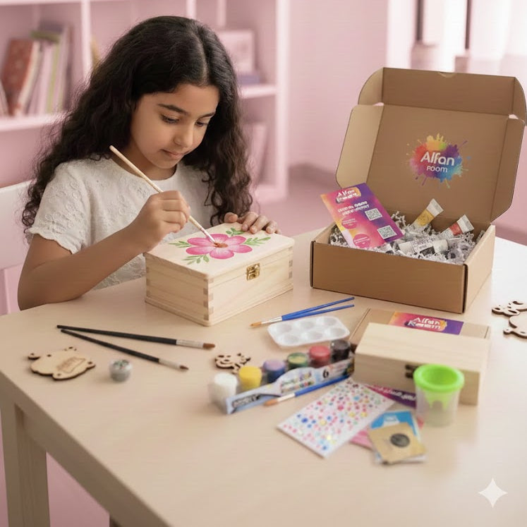 Girl painting a wooden box with art supplies on a table, Alfie Zoom box in the background.